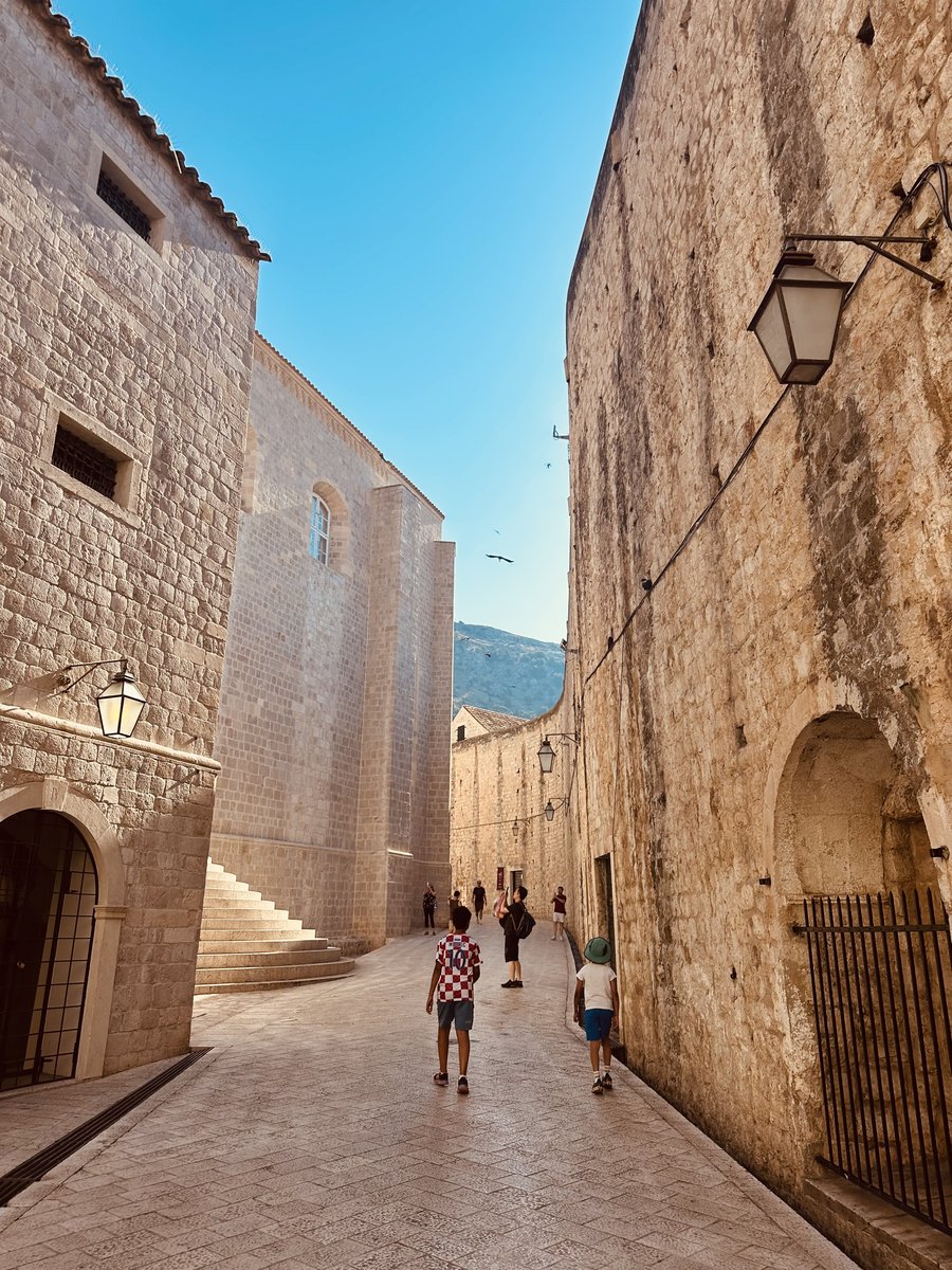 The boys walking down a Dubrovnik Old Town alley toward the cathedral