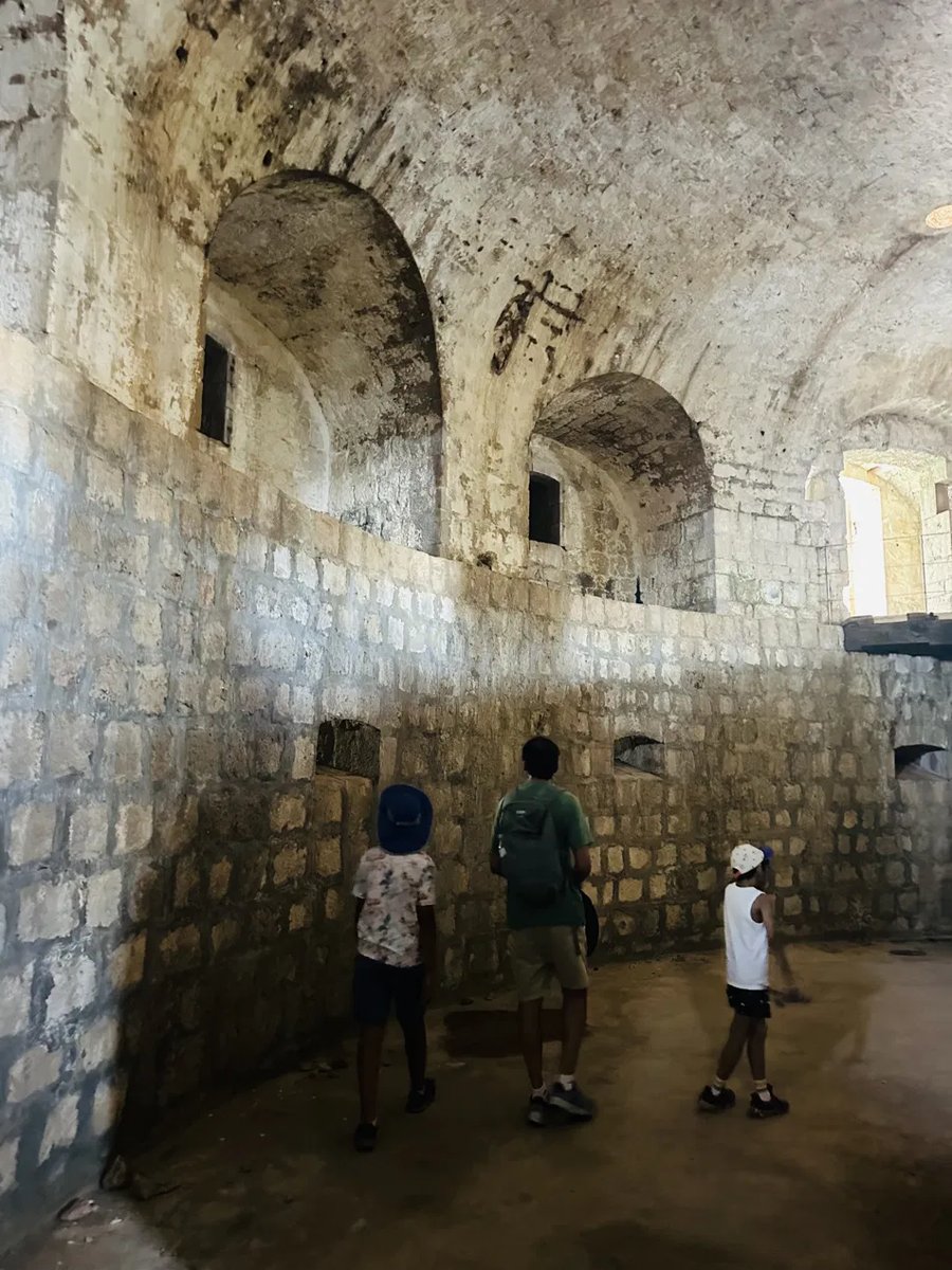 Kids exploring a stone fort corridor on Lokrum