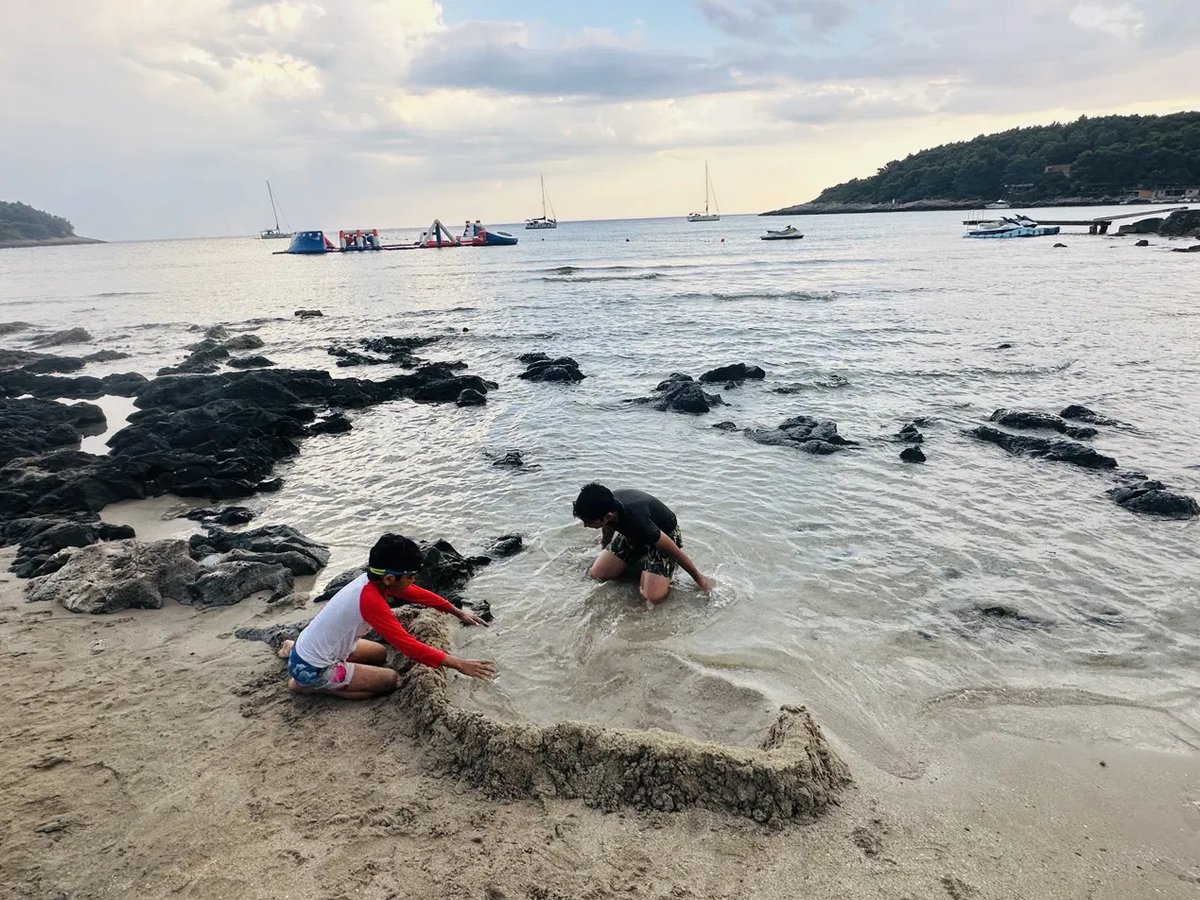 Kid digging in the sand at Pržina beach