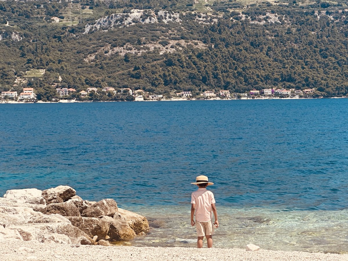 One of the boys standing at the water's edge at Pržina beach