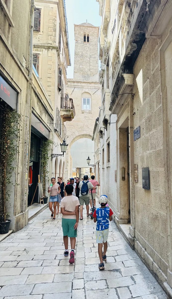 Narrow Trogir street leading to the cathedral bell tower