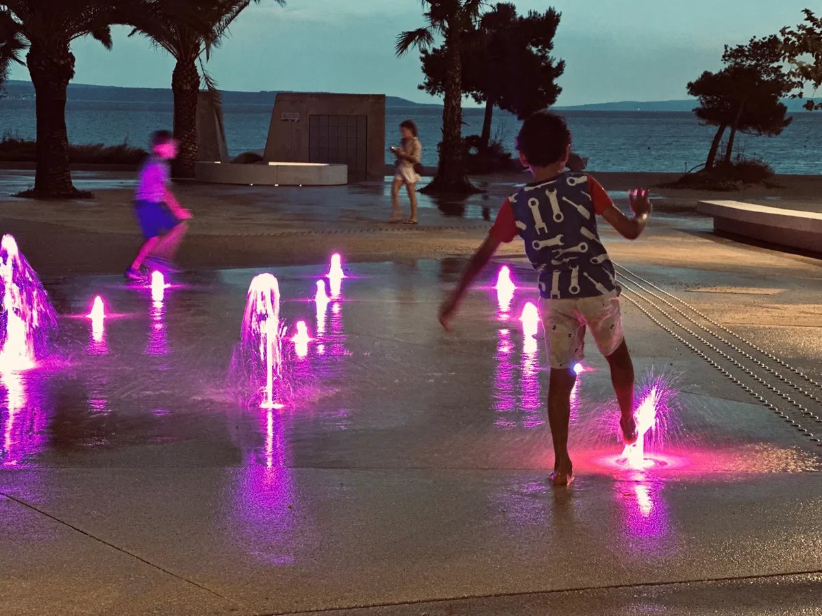 Kids playing in a fountain as the storm clears in Split